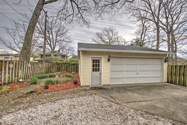 detached garage featuring fence