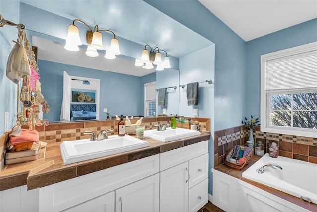 full bath with double vanity, a garden tub, backsplash, and a sink