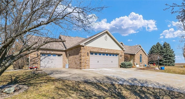 view of front of home featuring driveway, brick siding, and an attached garage