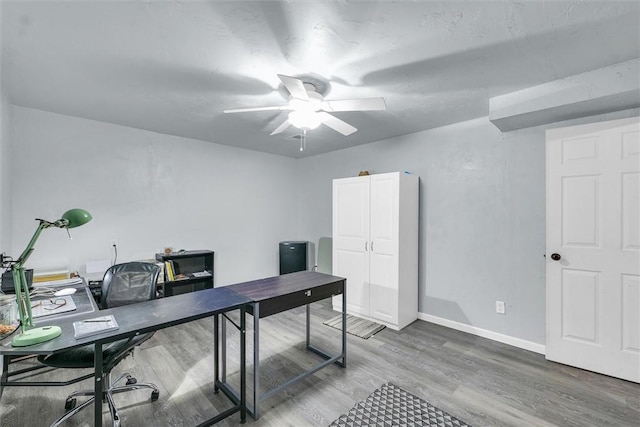 office with ceiling fan, baseboards, and wood finished floors