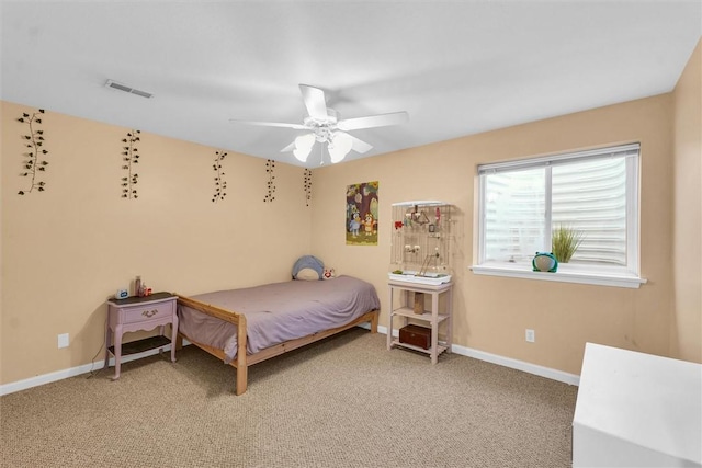 carpeted bedroom with visible vents, baseboards, and ceiling fan