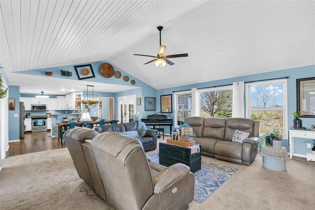 carpeted living room featuring lofted ceiling and ceiling fan with notable chandelier