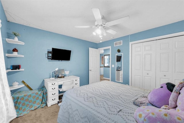 bedroom with visible vents, carpet floors, a closet, and ceiling fan