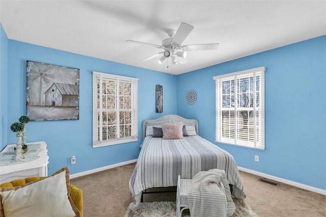 bedroom with visible vents, ceiling fan, baseboards, and carpet