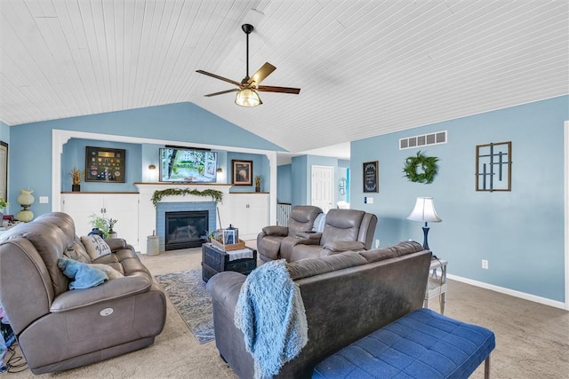 living area featuring visible vents, baseboards, carpet, a fireplace, and lofted ceiling