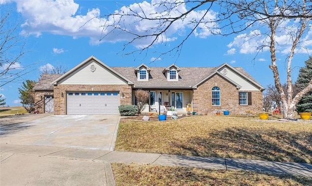 view of front facade with brick siding, driveway, an attached garage, and a front yard