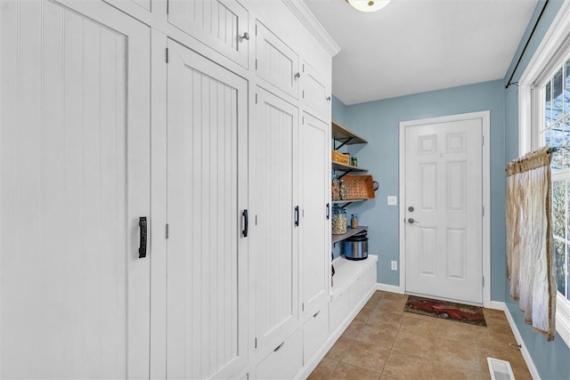 mudroom featuring light tile patterned floors, visible vents, and baseboards