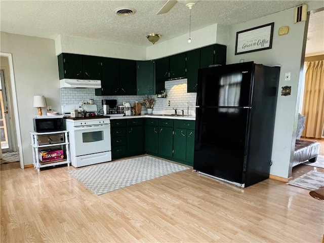 300 S Adams St, Herrick, IL 62431 - kitchen with black appliances, light wood-style floors, backsplash, a textured ceiling, and under cabinet range hood
