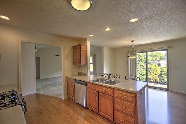 1310 Country Ln, Mt Zion, IL 62549 - kitchen featuring dishwasher, a peninsula, light wood-style flooring, a textured ceiling, and gas stove