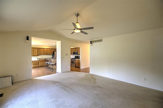 1310 Country Ln, Mt Zion, IL 62549 - unfurnished living room featuring a ceiling fan, light carpet, and lofted ceiling