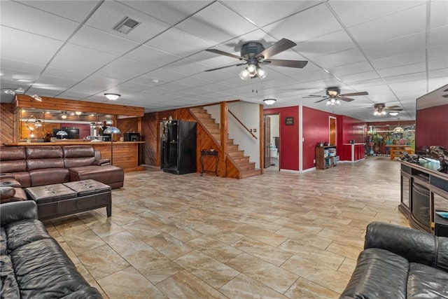 14480 N 1025th St, Effingham, IL 62401 - living room with wooden walls, ceiling fan, stairs, a drop ceiling, and bar area