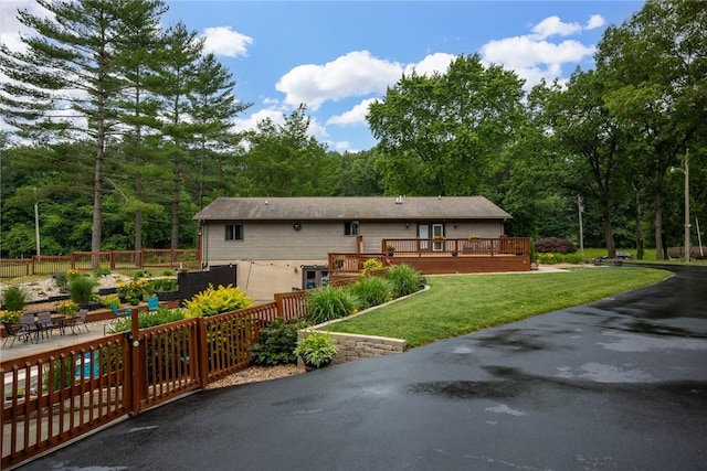 14480 N 1025th St, Effingham, IL 62401 - view of front of property featuring a deck, a wooded view, and a patio