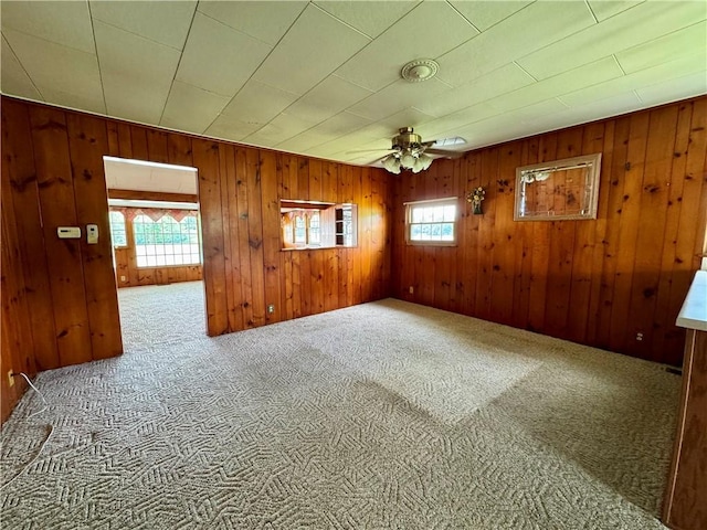 3475 Lake Paradise Rd, Mattoon, IL 61938 - empty room featuring a ceiling fan, carpet floors, and wood walls