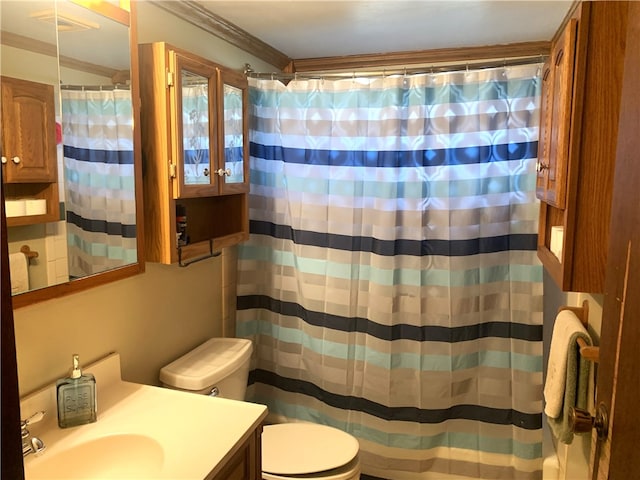 bathroom featuring a shower with shower curtain, vanity, toilet, and crown molding