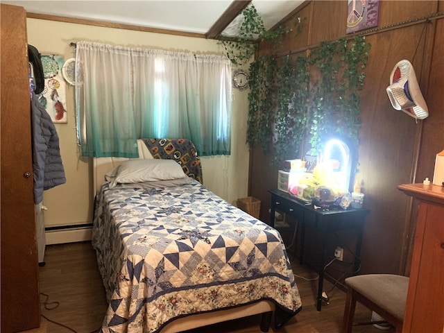 bedroom featuring a baseboard heating unit and wood finished floors