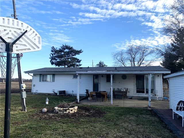 back of property with an outdoor fire pit, a patio area, a lawn, and cooling unit