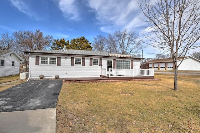 ranch-style home featuring a deck and a front yard