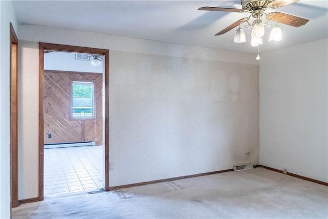 702 N Oakwood St, Effingham, IL 62401 - carpeted spare room featuring baseboards, a ceiling fan, baseboard heating, and visible vents
