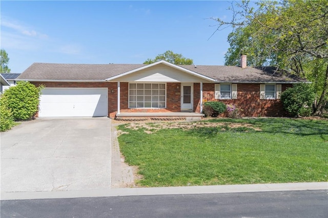 702 N Oakwood St, Effingham, IL 62401 - single story home with driveway, a chimney, brick siding, a front lawn, and an attached garage