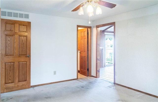 702 N Oakwood St, Effingham, IL 62401 - spare room featuring visible vents, a ceiling fan, baseboards, and light carpet