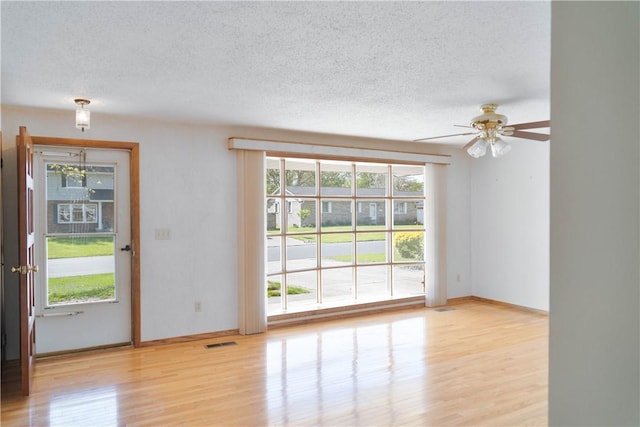 702 N Oakwood St, Effingham, IL 62401 - spare room with plenty of natural light, a textured ceiling, and wood finished floors