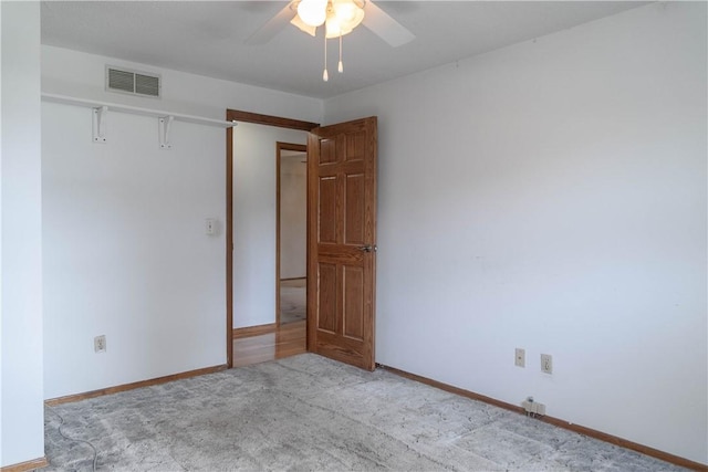 702 N Oakwood St, Effingham, IL 62401 - unfurnished room featuring visible vents, a ceiling fan, baseboards, and light carpet