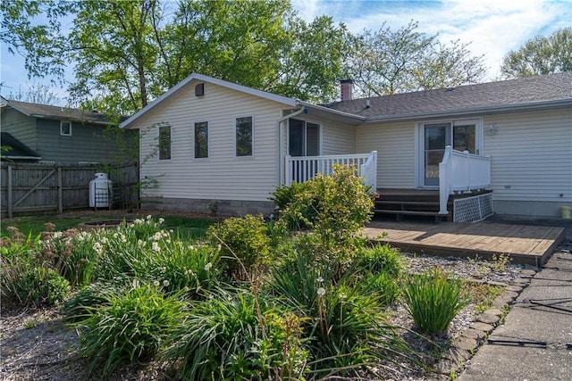 702 N Oakwood St, Effingham, IL 62401 - back of property featuring fence, a chimney, and a deck