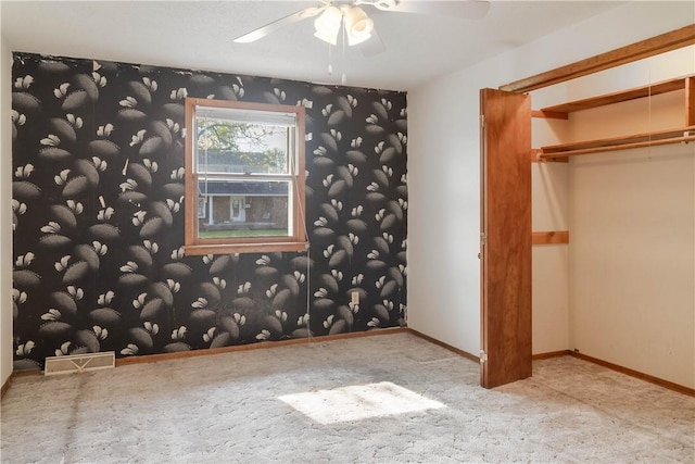 702 N Oakwood St, Effingham, IL 62401 - unfurnished bedroom featuring carpet, a ceiling fan, wallpapered walls, visible vents, and a closet