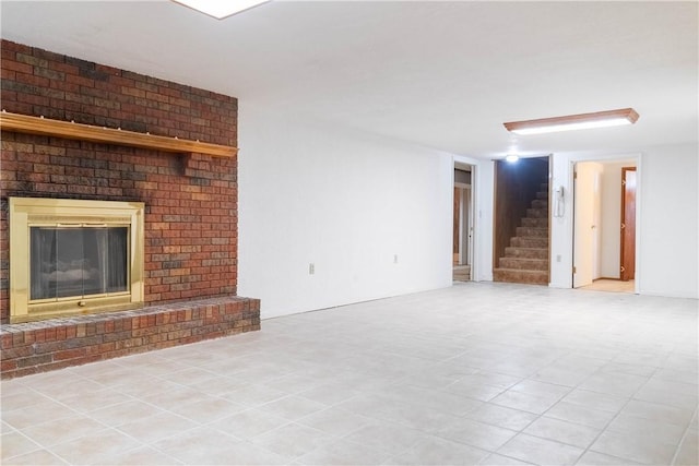 702 N Oakwood St, Effingham, IL 62401 - unfurnished living room with a brick fireplace and stairway