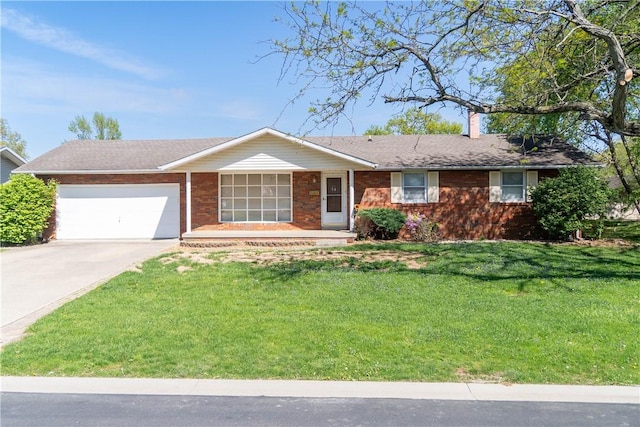 702 N Oakwood St, Effingham, IL 62401 - ranch-style home featuring a garage, a front yard, a chimney, brick siding, and driveway