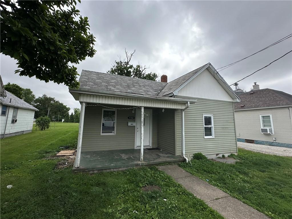 430 W Carroll St, Paris, IL 61944 - view of front of property with a front yard, a porch, cooling unit, and a chimney