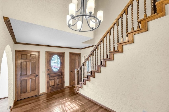 4554 Nicklaus Ct, Decatur, IL 62526 - foyer entrance with a chandelier, a textured wall, stairs, baseboards, and wood finished floors