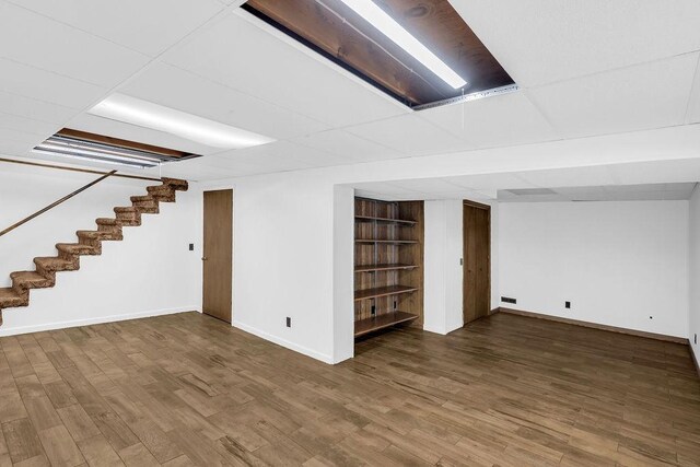 4554 Nicklaus Ct, Decatur, IL 62526 - finished below grade area with stairs, baseboards, wood finished floors, and built in shelves