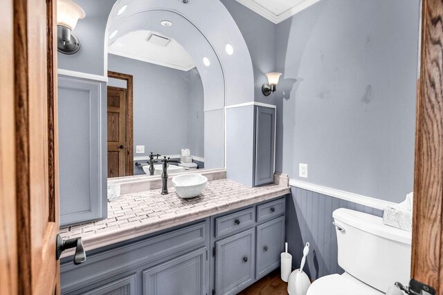 4554 Nicklaus Ct, Decatur, IL 62526 - bathroom featuring toilet, a wainscoted wall, vanity, and crown molding