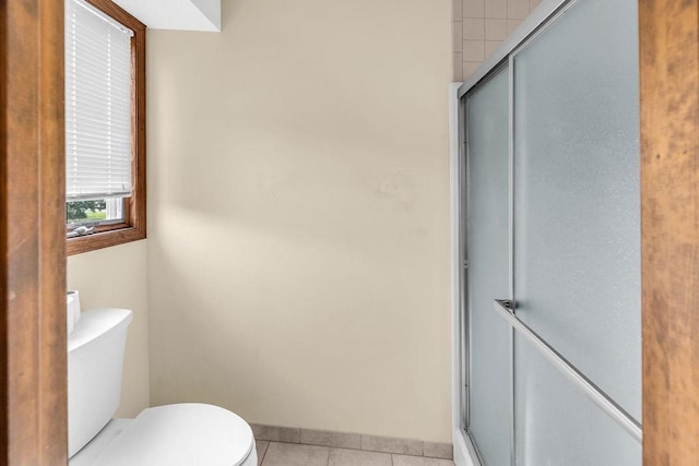 4554 Nicklaus Ct, Decatur, IL 62526 - full bathroom with toilet, a shower stall, tile patterned floors, and baseboards