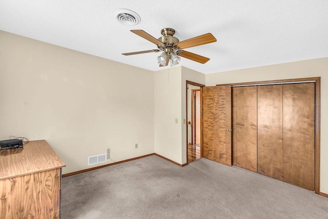 4554 Nicklaus Ct, Decatur, IL 62526 - unfurnished bedroom with carpet, baseboards, a ceiling fan, and a closet