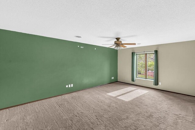 4554 Nicklaus Ct, Decatur, IL 62526 - empty room with carpet, a textured ceiling, ceiling fan, and baseboards
