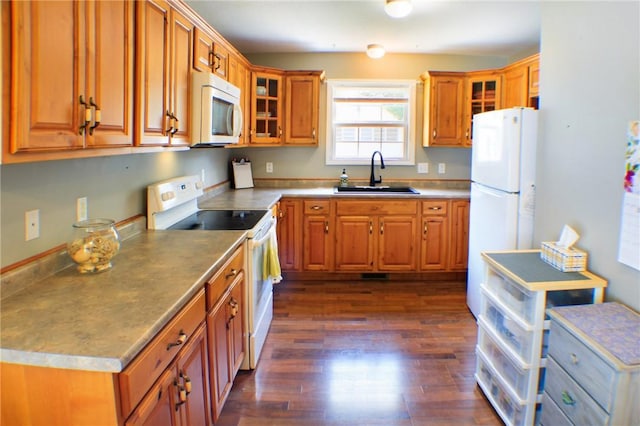 1203 Adams Ave, Charleston, IL 61920 - kitchen with white appliances, brown cabinetry, dark wood-style floors, and glass insert cabinets