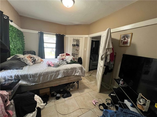 bedroom with light tile patterned floors