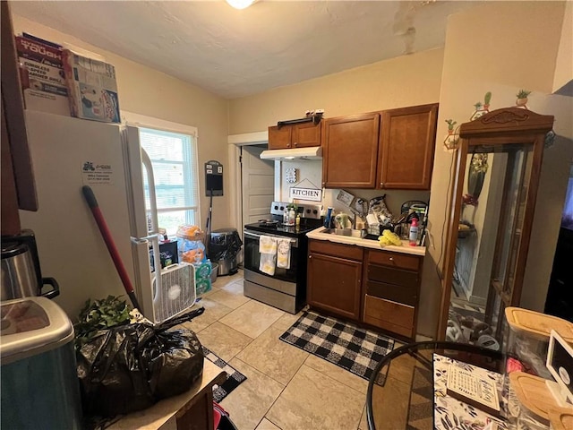 kitchen featuring light countertops, light tile patterned floors, under cabinet range hood, and electric stove