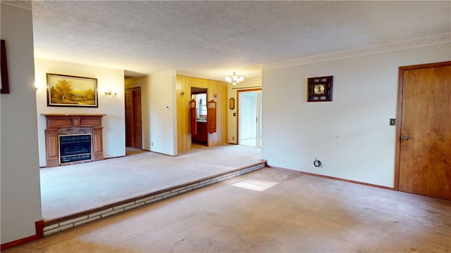 unfurnished living room with light colored carpet, a notable chandelier, and a textured ceiling