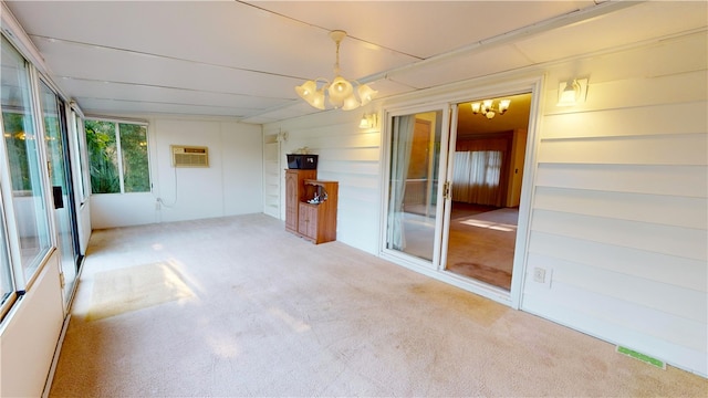 interior space featuring a wall mounted AC and a chandelier