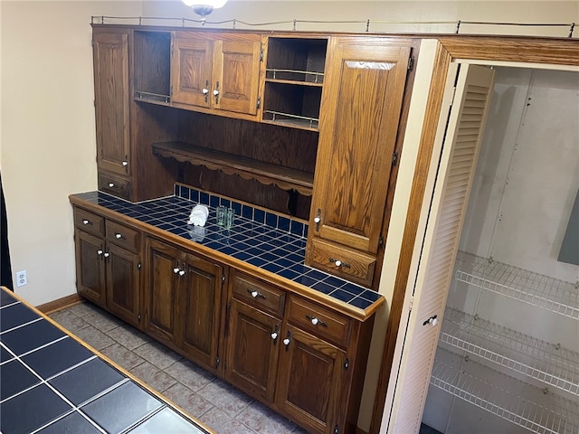 kitchen with light tile patterned floors and tile counters