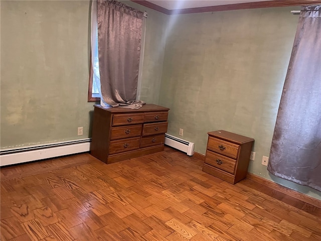 bedroom featuring ornamental molding, a baseboard radiator, and light hardwood / wood-style flooring