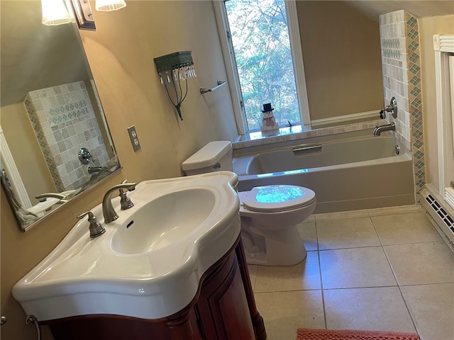 bathroom featuring a bathing tub, tile patterned flooring, vanity, and toilet