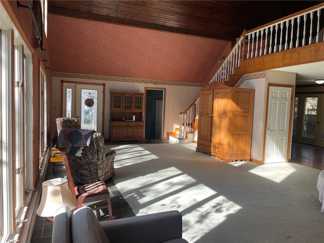 living room featuring beamed ceiling, a healthy amount of sunlight, and high vaulted ceiling