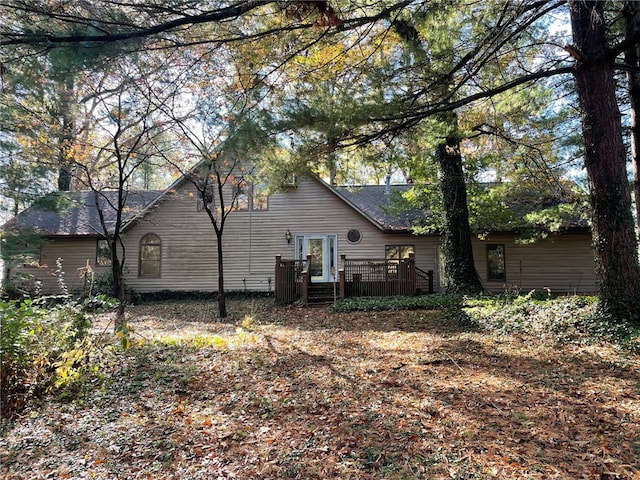 rear view of property featuring a deck