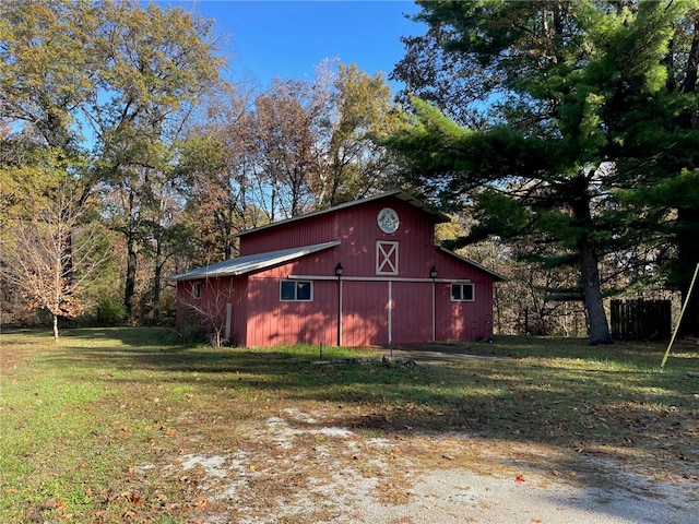 view of outbuilding featuring a yard