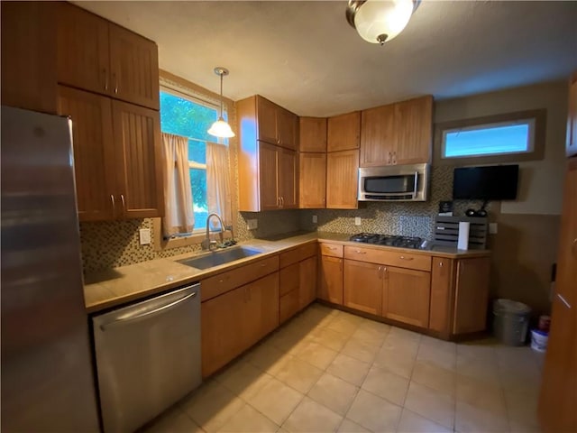 1105 Edgar Ave, Mattoon, IL 61938 - kitchen with appliances with stainless steel finishes, decorative backsplash, light countertops, and pendant lighting