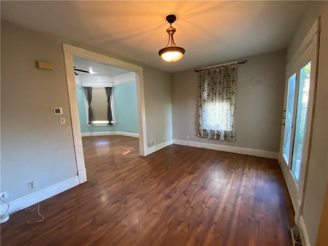 1105 Edgar Ave, Mattoon, IL 61938 - empty room featuring dark wood finished floors and plenty of natural light